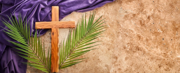 Lent season Holy week and Good friday concept Palm leave and cross on stone background