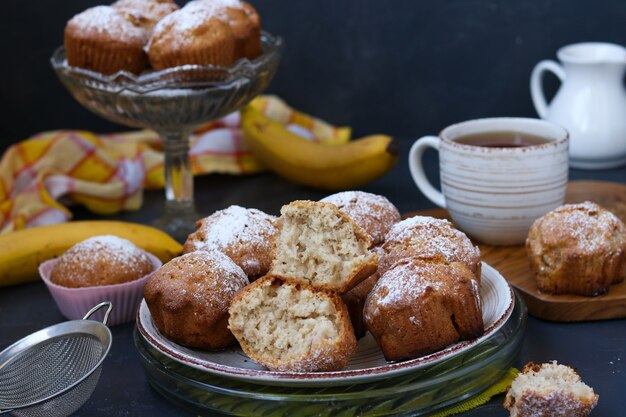 Lenten muffins with bananas are located on plates against a dark