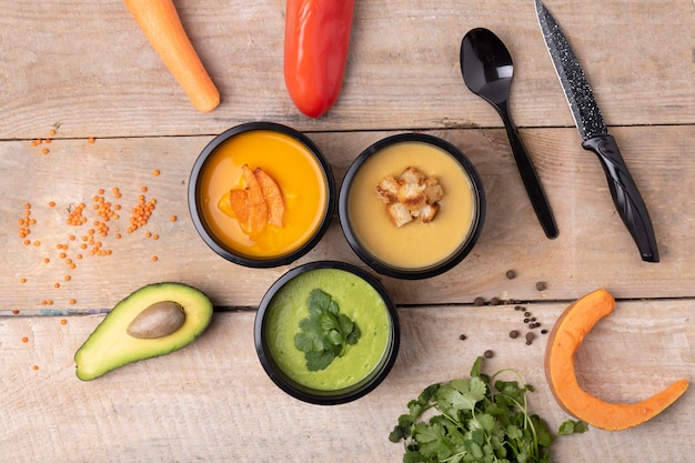 Lentil cream soup, pumpkin soup and raw vegetables