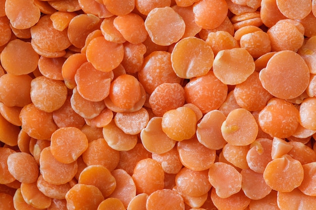 Lentil grains orange, in bulk close-up macro view, top view