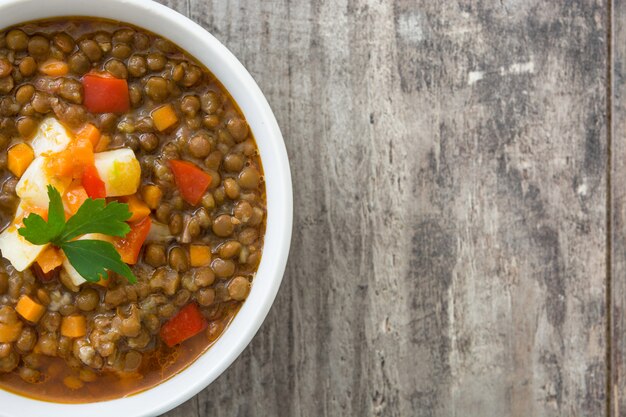 Lentil soup in a bowl top view copy space