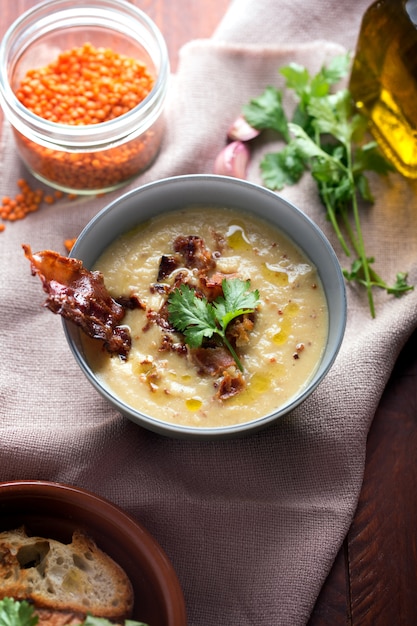 Lentil soup puree with bacon in a bowl . Close up shot