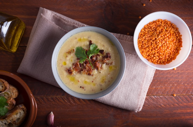 Lentil soup puree with bacon in a bowl