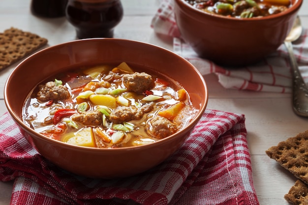 Lentil soup with meatballs and pepper and onion