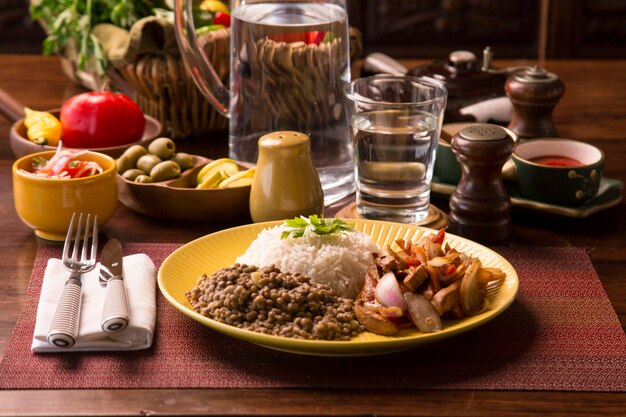 Lentils sauted chicken rice peruvian traditional food mise en place wooden table