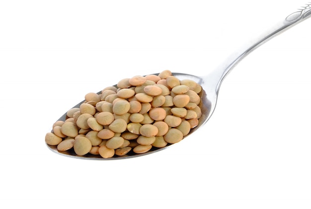 Photo lentils in spoon isolated on white