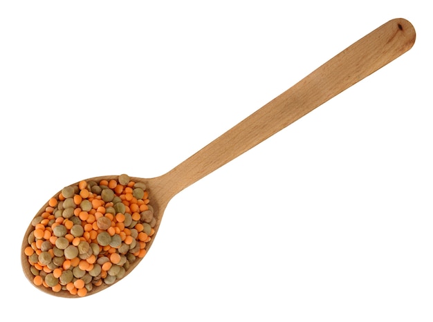 Lentils in the wooden spoon isolated on white background. Mix of red and green lentils