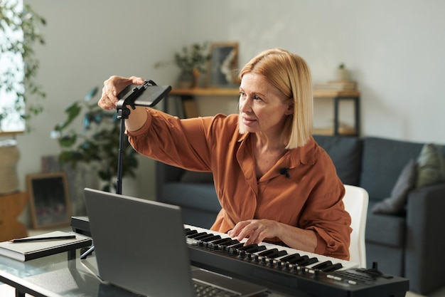 Leraar die gadgets gebruikt om muzikale lessen op te nemen