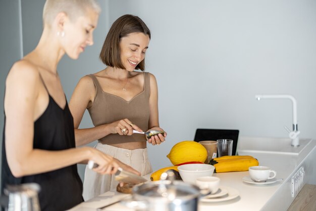 Lesbian couple cooking at home