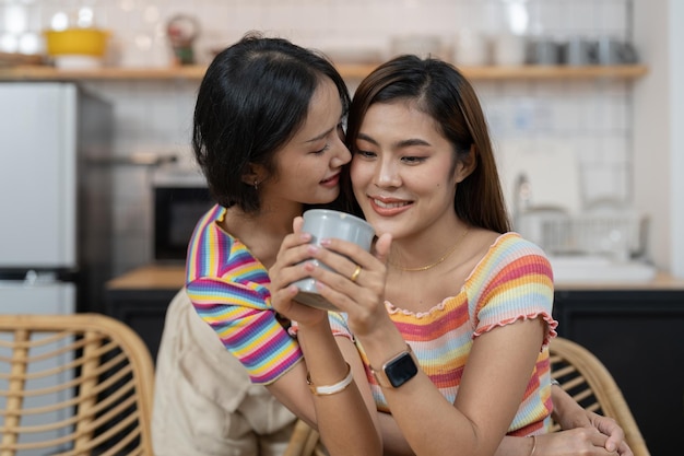 Lesbian couple embracing at home