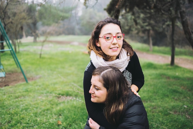 Lesbian couple hugging at the park. Copy space.