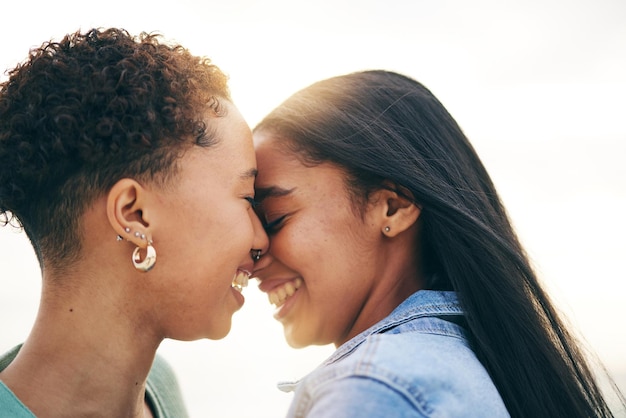 Photo lesbian couple love and intimate outdoor at sunset bonding and romance on date together happy gay women and forehead touch for care commitment and loyalty trust and support for lgbtq people