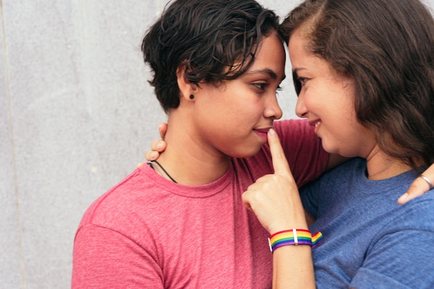 Lesbian Couple Smiling And Hugging Outside