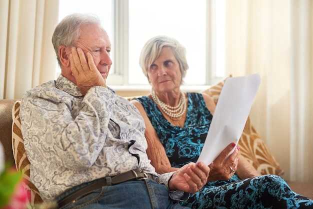 Less income challenging outcomes Shot of a senior couple going through their paperwork together at home and looking worried