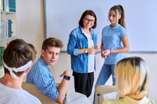 Lesson in classroom with digital screen for group of teenagers