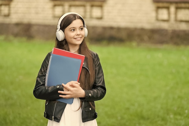 Lesson that sounds Small learner wear headphones Little child hold books for lesson Private lesson Listening comprehension skills Music lesson School and education