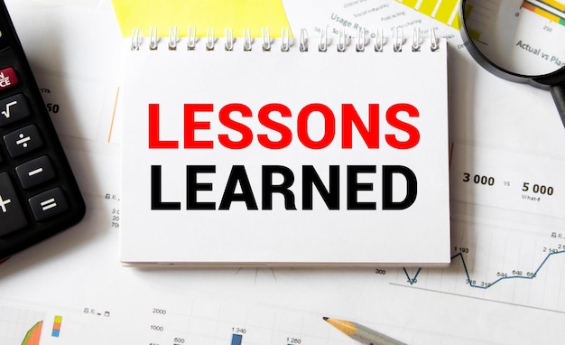 Lessons learned text concept write on notebook