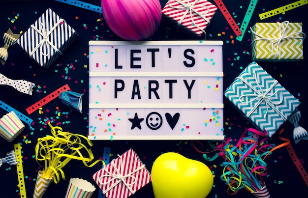 Let's party and celebrate concepts with text on cinema light box and colorful element