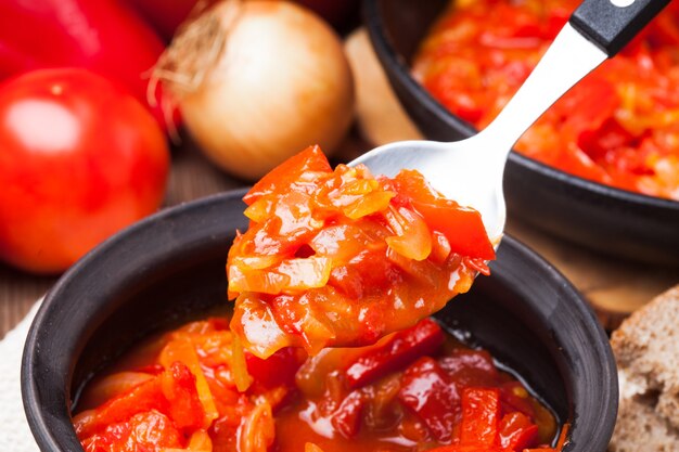 Photo letcho ingredients and dish in a bowl and spoon