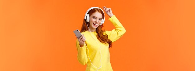 Lets dance cheerful carefree modern hipster girl with red curly hair and freckles dancing lift hand