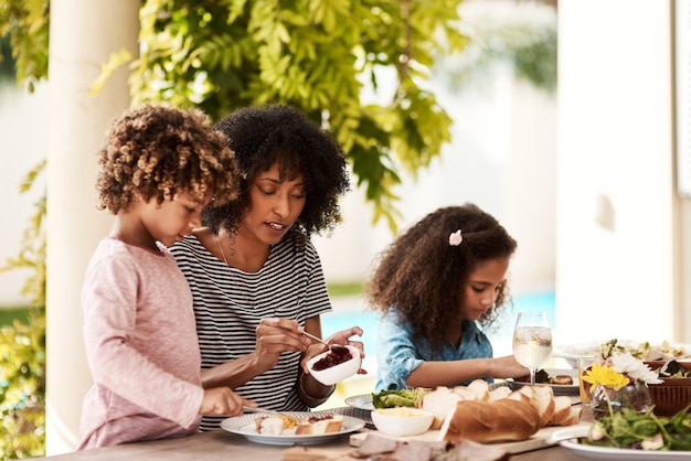 子供たちを食べましょう家で子供たちと食事を楽しんでいる若い女性のクロップドショット