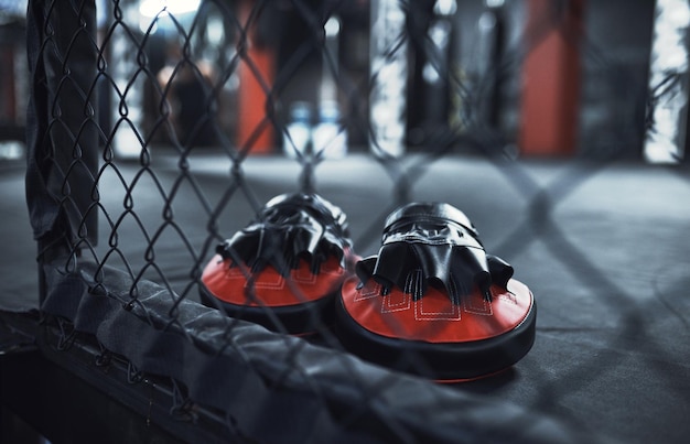 Lets get punching and sparring Still life shot of a pair of boxing mitts in a gym