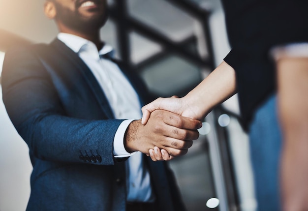 Lets join forces to become the best Closeup shot of two unrecognizable businesspeople shaking hands in an office