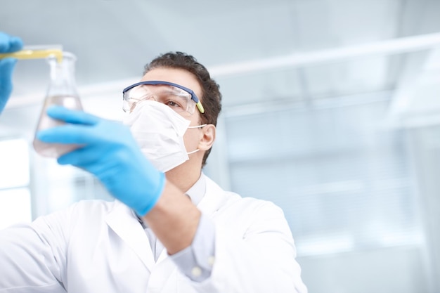 Lets see what happens low angle shot of a chemist mixing chemicals