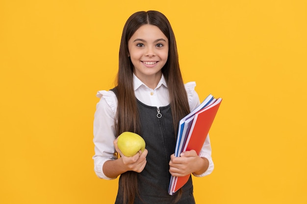 Lets start to learn for a better future. Happy kid smile holding apple and books. School education. Knowledge day. September 1. Learn today.