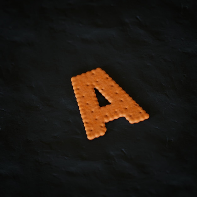 Photo a letter 3d rendered realistic cookie on black background character