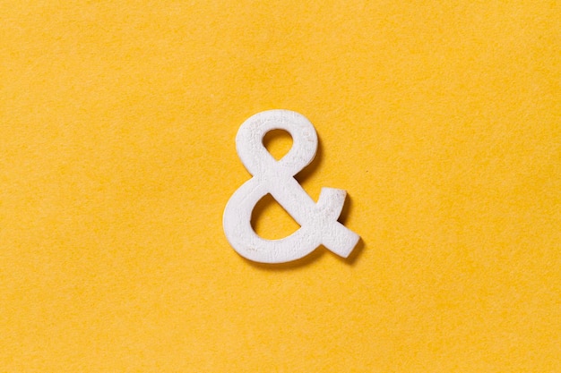 Letter of the alphabet isolated on yellow background top view