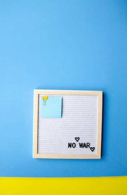 Letter board with the phrase no war on a blue background