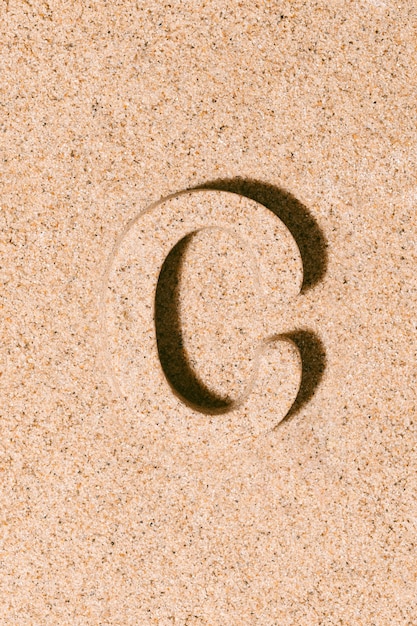 Letter C van het zand geïsoleerd op het strand zand concept van zomer alfabet