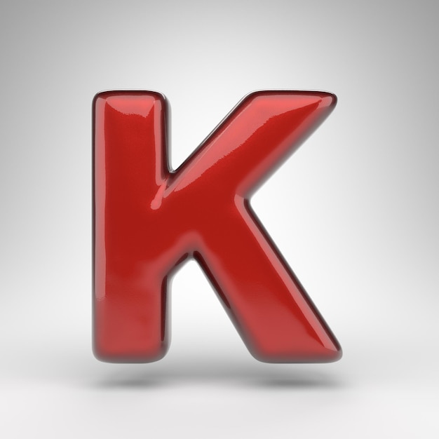 Letter K uppercase on white background. Red car paint 3D rendered font with glossy metallic surface.