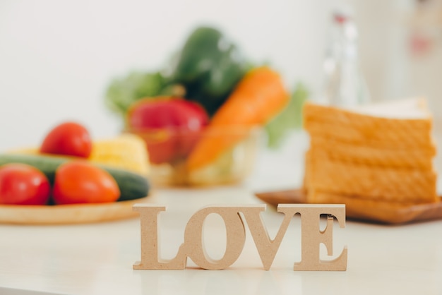 Letter LOVE on a wooden table in the rustic kitchen