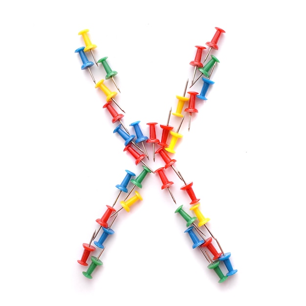 Letter X English alphabet from multicolored stationery office buttons, isolate on white background