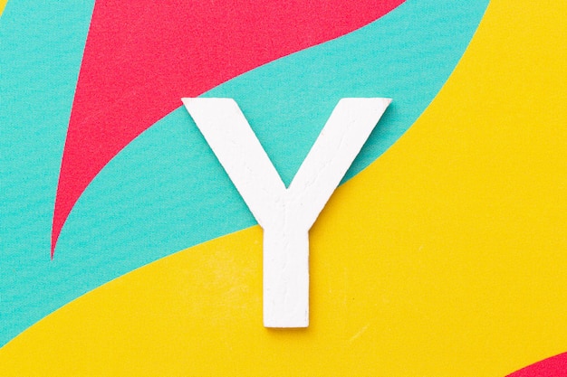 Letter Y of the alphabet on colored background top view