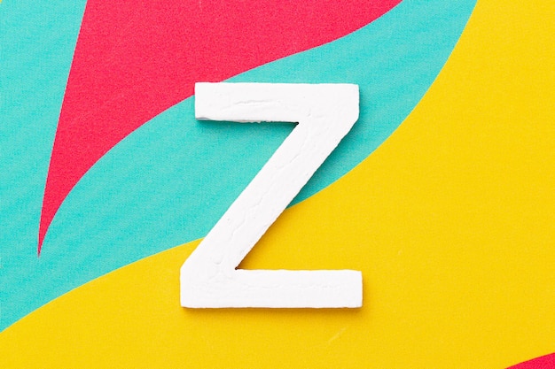 Photo letter z of the alphabet on colored background top view