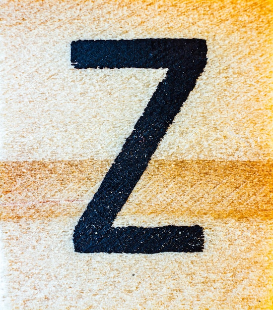 Letter Z laser engraved on balsa wood macro close up texture detail