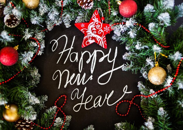 Photo lettering happy new year on black board