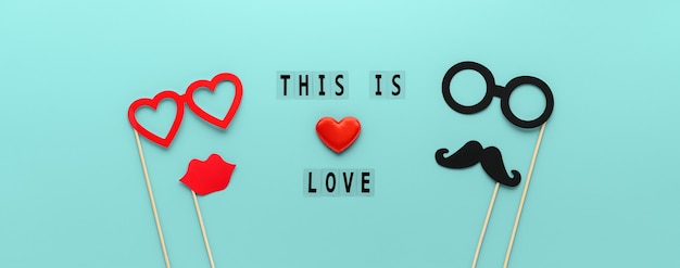 Lettering This is Love and paper props mustache, lips and glasses on pastel