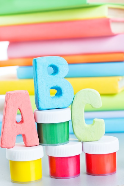 Photo letters abc and stack of books on a white background