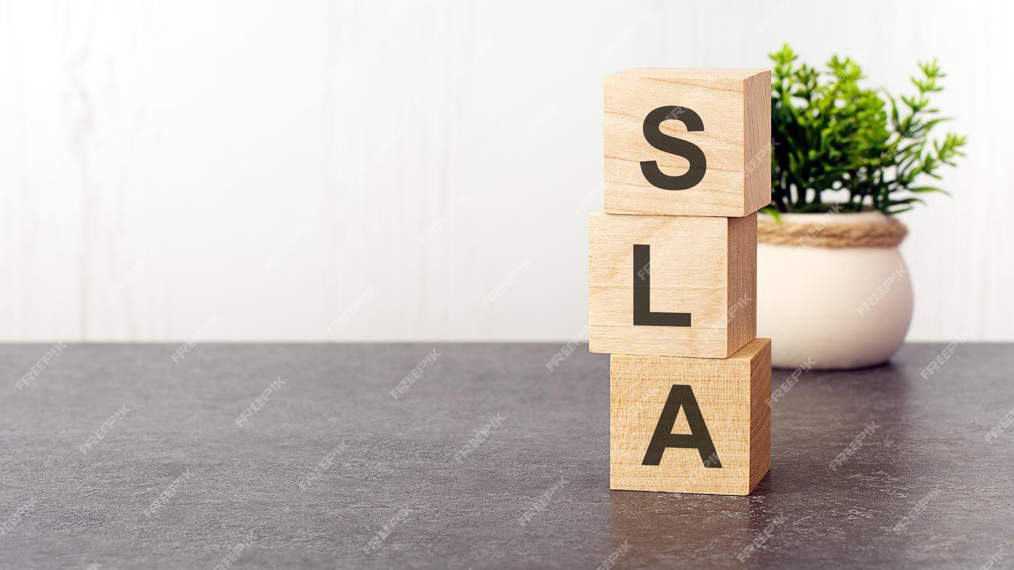 Premium Photo  Letters of the alphabet of sla on wooden cubes green plant  white background sla short for service level agreement