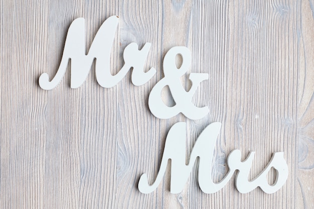 Letters mr and mrs on a wooden background. Top view.