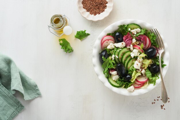 Lettuce salad cucumber radish salad with cottage cheese and flax seeds olive oil salad Healthy diet food Diet menu and balanced diet Top view