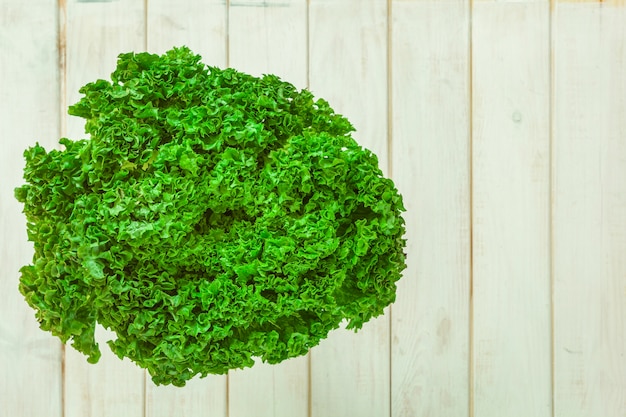 Lettuce on white wooden boards.