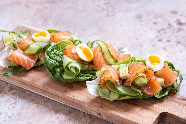 Lettuce wrapped smoked salmon tacos with fresh cucumber, avocado and quail eggs