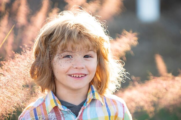 Leuk kinderportret, gelukkig jongenskind lacht en geniet van het levensportret van een jonge jongen in het natuurpark of