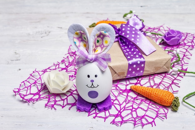 Leuk konijn uit het ei, geschenkdoos, feestelijk decor in lila tinten