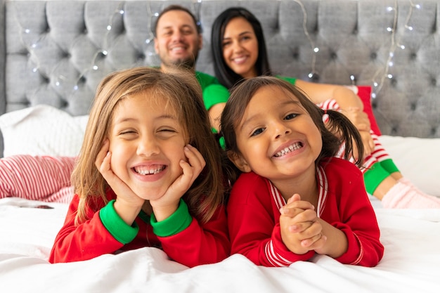 Leuke familie die met Kerstmis in hun bed ligt